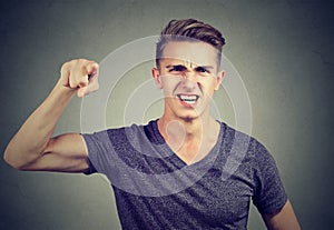 Angry young man accusing someone screaming