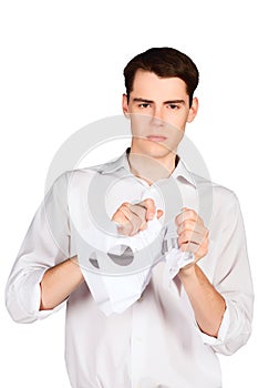 Angry young man crumples tears paper