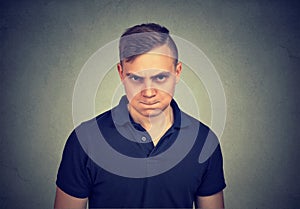 Angry young man looking at camera