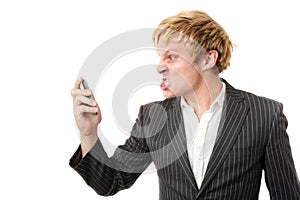 Angry young man shouting on the phone