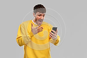 Angry young man with smartphone