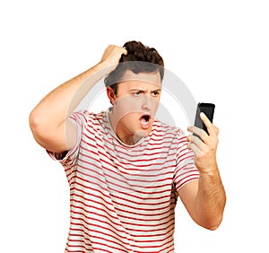 Angry young man talking on mobile phone and holding on to head. emotional guy on white background