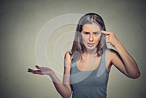 Angry young woman gesturing asking are you crazy?