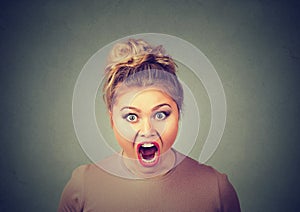 Angry young woman having nervous atomic breakdown screaming