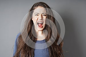 Angry young woman screaming and shouting