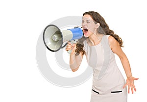 Angry young woman shouting thought megaphone