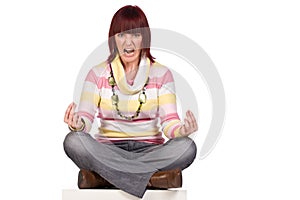 Angry young woman sitting cross-legged, isolated