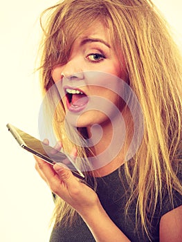 Angry young woman talking on phone