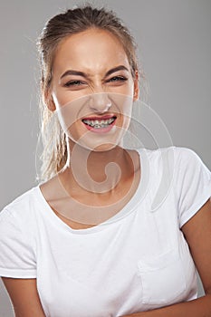 Angry young woman wearing braces on teeth