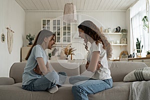 Parent-Teen misunderstandings. Disrespectful child daughter arguing quarreling with mom at home. photo