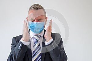 Anguished man throwing up his hands and screwing up his eyes photo