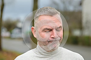 Anguished or troubled senior man outdoors on street