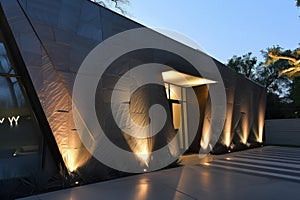 angular modern home front with spotlights on textured walls