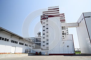 Animal feed factory. Modern industrial building in sunny day