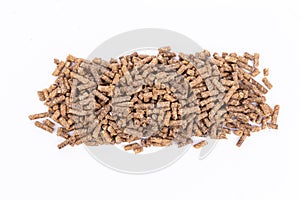 Animal feed. Sunflower granulated feed  on white background, close-up. Animal cattle food pellets. Heap of animal feed pellets  on
