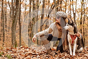 Animal husbandry. Girl pretty stylish woman walking with husky dog autumn forest. Unconditional love. Pedigree dog