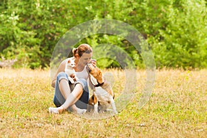 Animal lover sitting outside with her pets