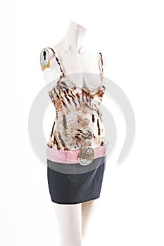 Animal pattern top black skirt on mannequin full body shop display. Woman fashion styles, clothes on white studio background.