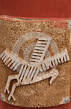 An animal relief decorates a pillar