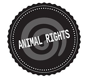 ANIMAL-RIGHTS text, on black sticker stamp.