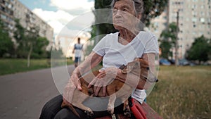 Animal theme is a lonely old woman best friend. Caucasian 90 years old senior female is happy to spend time with her pet photo