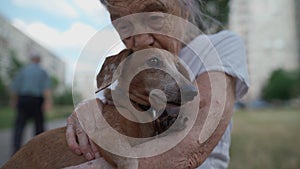 Animal theme is a lonely old woman best friend. Caucasian 90 years old senior female is happy to spend time with her pet photo