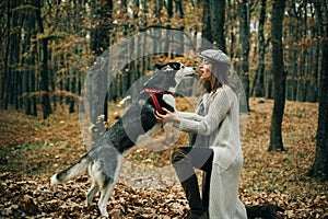 Animal training. Girl pretty stylish woman walking with husky dog autumn forest. Pedigree dog concept. Best friends