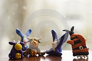 Animals rabbits, cows and fish from multi-colored plasticine, which hardens. Children`s creativity. Funny clay toys