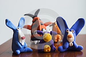 Animals rabbits, cows and fish from multi-colored plasticine, which hardens. Children`s creativity. Funny clay toys