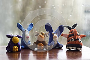 Animals rabbits, cows and fish from multi-colored plasticine, which hardens. Children`s creativity. Funny clay toys