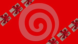 Animated background of gift boxes with a red bow on a red background with place for inserting , the concept of