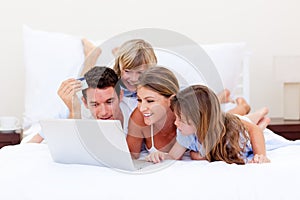 Animated family buying online lying down on bed