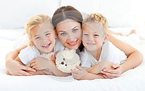 Animated siblings with their mother lying on a bed