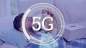 Animation of 5G written with scope scanning over sick man lying in bed blowing his nose