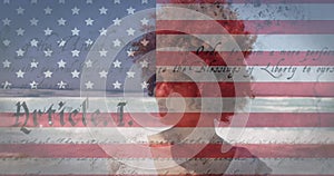 Animation of American flag waving and constitution text over mixed race woman