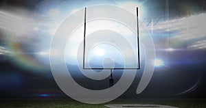 Animation of american football goalposts and cloudy sky at floodlit stadium