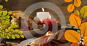 Animation of autumn leaves falling over thanksgiving dinner background