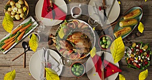 Animation of autumn leaves over thanksgiving dinner background