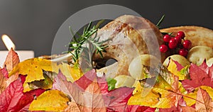 Animation of autumn leaves over thanksgiving dinner background