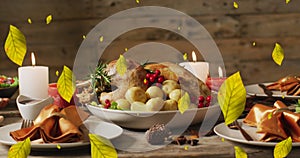 Animation of autumn leaves over thanksgiving dinner background