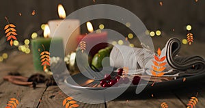 Animation of autumn leaves over thanksgiving dinner place setting background