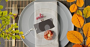 Animation of autumn leaves over thanksgiving dinner place setting background