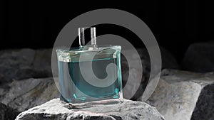 Animation of a blue perfume bottle in a modern container placed on rocks