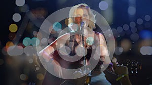 Animation on blurred night road traffic over caucasian female singer on concert