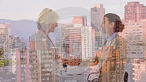 Animation of businesswomen handshake over cityscape