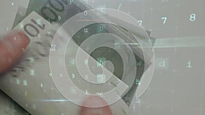 Animation of changing numbers and virus alert over hand counting euro banknotes