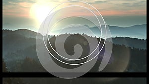 Animation of circular scope and slipping frame over idyllic misty mountain landscape at sunset