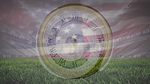 Animation of clock and flag of america over low angle view of grass and empty stadium