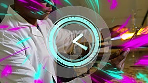 Animation of clock moving over african american male scientist working in lab