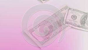 Animation of close up of dollar bills flying against pink gradient background